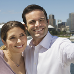 lugares-para-visitar-en-vancouver-pareja-de-turistas-tomandose-selfier-con-ciudad-atras